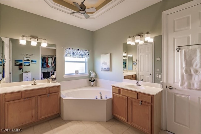 bathroom featuring a bathing tub, tile patterned floors, ceiling fan, and vanity