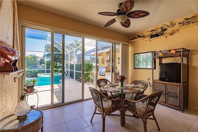 tiled dining space featuring ceiling fan