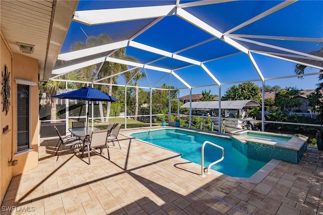 view of pool featuring an in ground hot tub, a lanai, and a patio