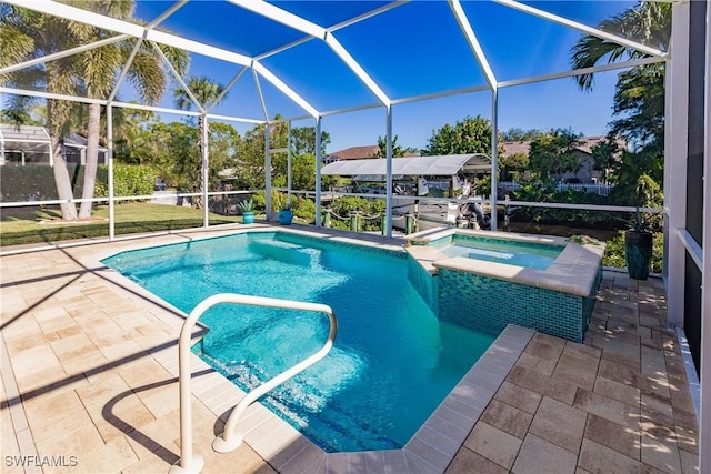 view of swimming pool with a lanai, a patio area, and an in ground hot tub