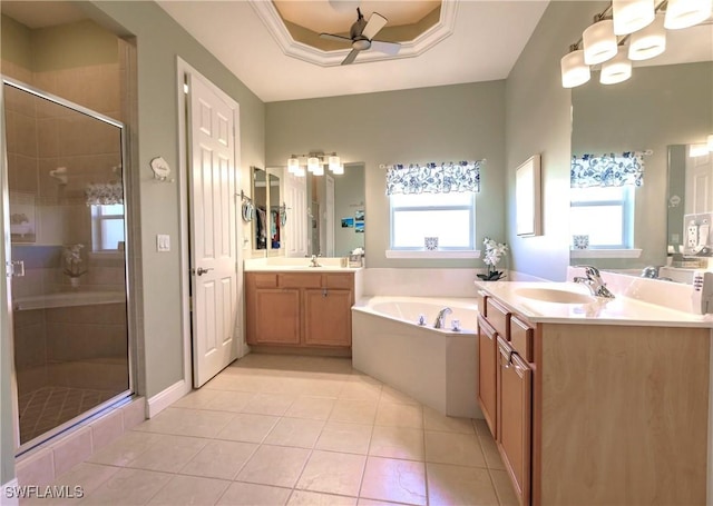 15192 Riverbend Blvd, North Fort Myers, FL 33917 - bathroom with a ceiling fan, a garden tub, two vanities, a shower stall, and tile patterned flooring