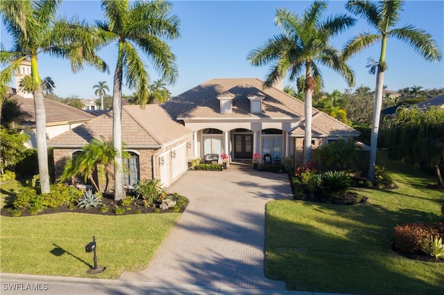 view of front of house with a porch and a front lawn