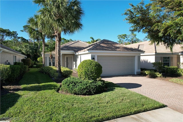 view of front of property featuring a garage and a front lawn