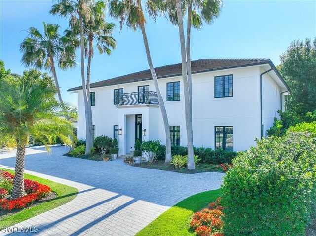 55 E Burning Tree Dr, Naples, FL 34105 - view of front of house with a balcony and stucco siding