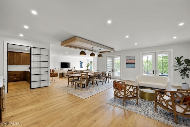 dining space featuring french doors and light hardwood / wood-style flooring