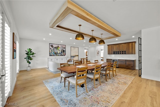 dining room featuring beverage cooler and light wood-type flooring