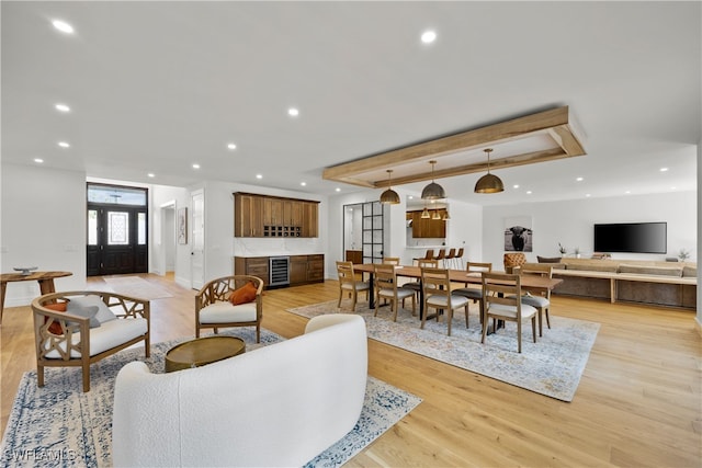 living room featuring french doors, beverage cooler, and light wood-type flooring