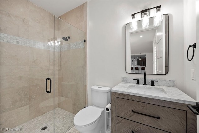 55 E Burning Tree Dr, Naples, FL 34105 - bathroom featuring toilet, a stall shower, and vanity
