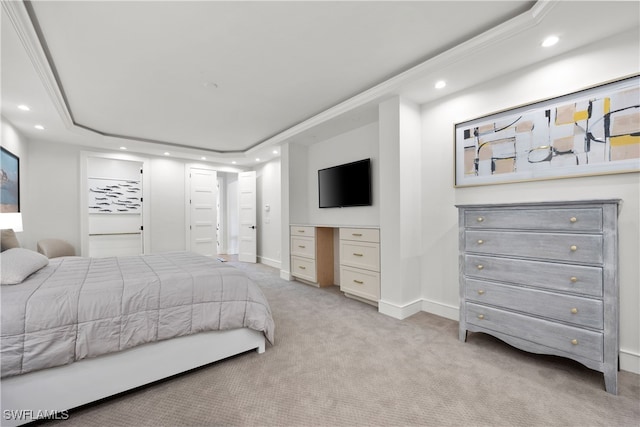 carpeted bedroom featuring a raised ceiling and crown molding