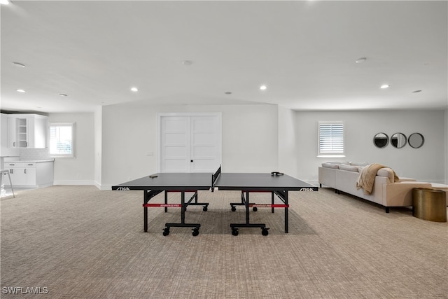 recreation room with light carpet