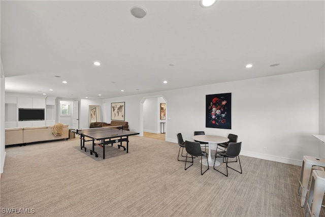 recreation room featuring light colored carpet