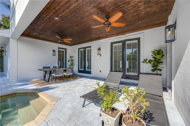55 E Burning Tree Dr, Naples, FL 34105 - view of patio with french doors, a ceiling fan, and outdoor dining space