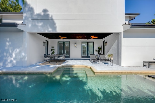 view of pool with ceiling fan and a patio area