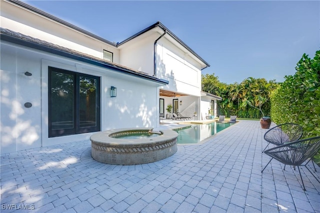 55 E Burning Tree Dr, Naples, FL 34105 - view of patio / terrace with french doors and a pool with connected hot tub