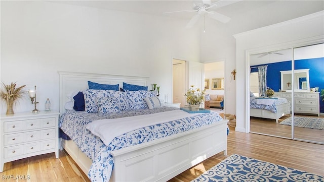 bedroom with ceiling fan, a closet, and light wood-type flooring