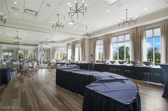 interior space with crown molding, hardwood / wood-style floors, and a healthy amount of sunlight