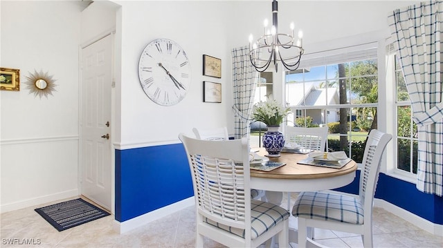 dining area with a chandelier and light tile patterned flooring