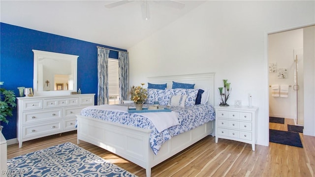 bedroom with ceiling fan, light hardwood / wood-style floors, and lofted ceiling