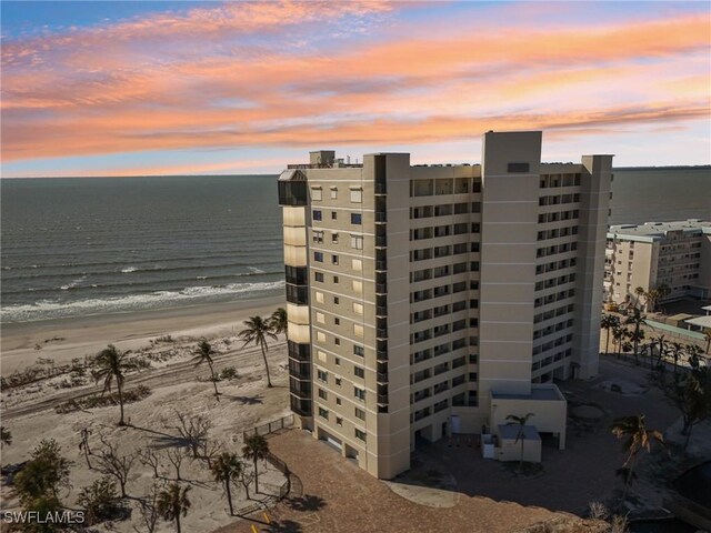 outdoor building at dusk with a view of the beach and a water view