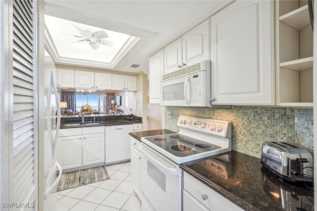 kitchen with white cabinetry, white appliances, and light tile patterned flooring