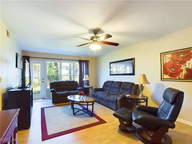 living room with ceiling fan, french doors, and light hardwood / wood-style floors