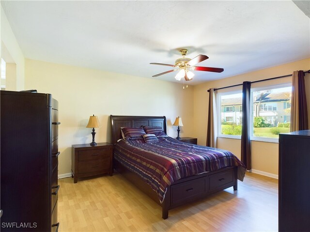 bedroom with ceiling fan and light wood-type flooring