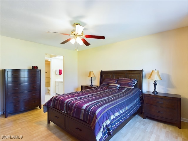 bedroom featuring ensuite bath, ceiling fan, and light hardwood / wood-style floors