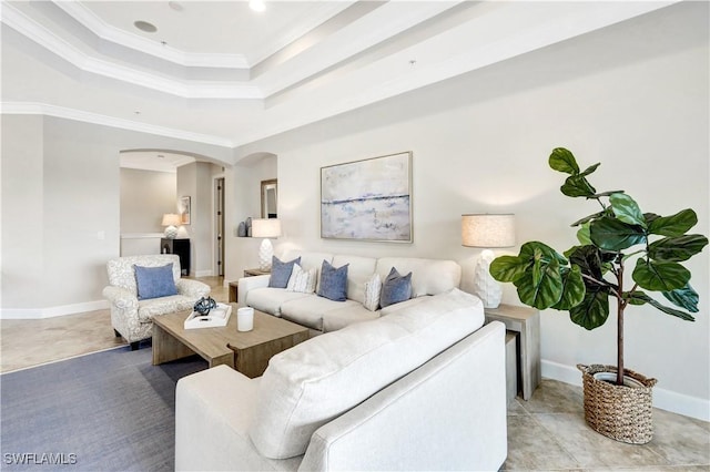 living room featuring a tray ceiling and crown molding