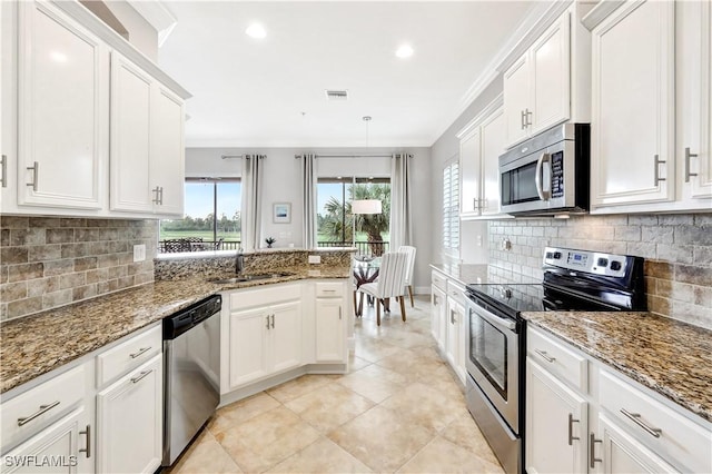 kitchen with stainless steel appliances, sink, and white cabinets