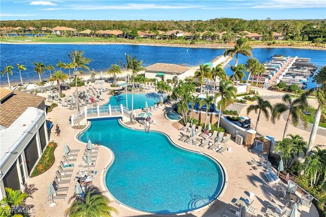 view of swimming pool with a water view and a patio area