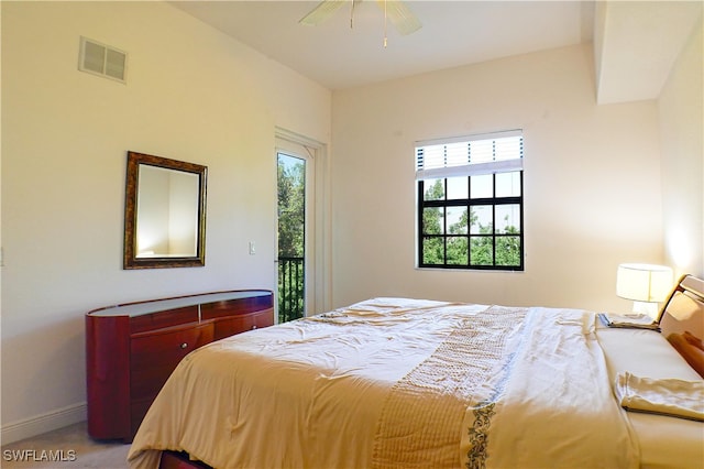 carpeted bedroom featuring access to outside, multiple windows, and ceiling fan