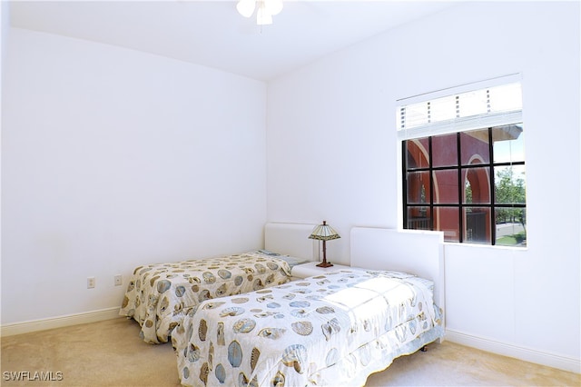 bedroom with light colored carpet and ceiling fan