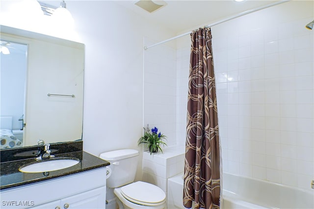 full bathroom featuring shower / tub combo with curtain, vanity, and toilet