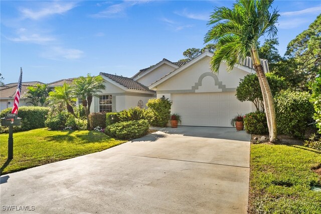 view of front of property with a garage and a front yard