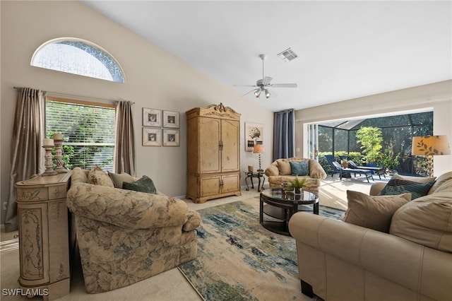 carpeted living room featuring ceiling fan and high vaulted ceiling