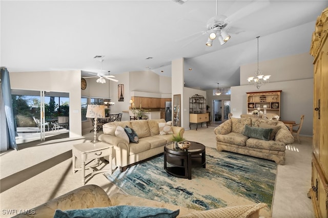 living room with ceiling fan with notable chandelier, light carpet, and high vaulted ceiling