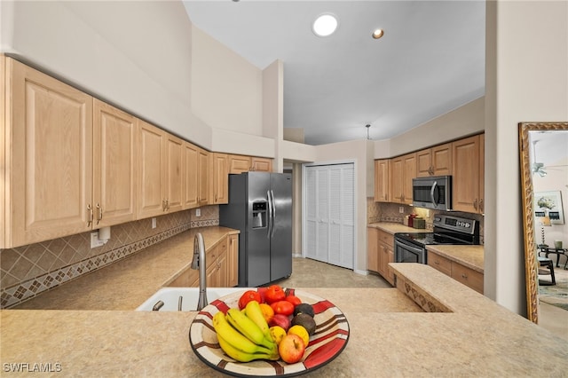 kitchen with backsplash, light brown cabinets, sink, and appliances with stainless steel finishes