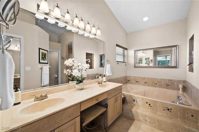 bathroom with vanity, a relaxing tiled tub, toilet, and lofted ceiling