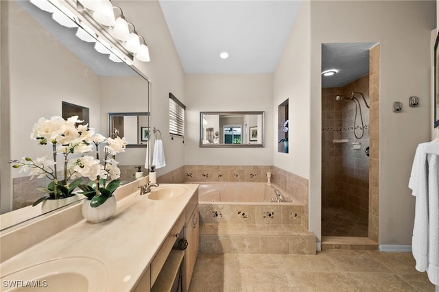 bathroom with vanity, tile patterned flooring, and plus walk in shower