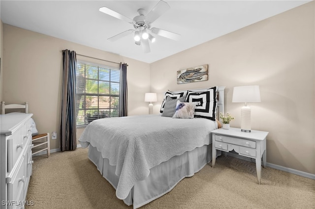 bedroom with ceiling fan and light carpet