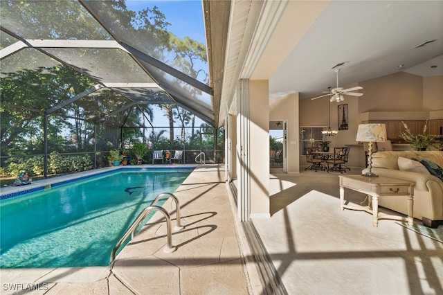 view of pool with ceiling fan, a lanai, and a patio