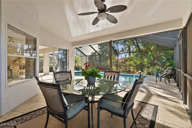 sunroom / solarium featuring vaulted ceiling, plenty of natural light, and ceiling fan