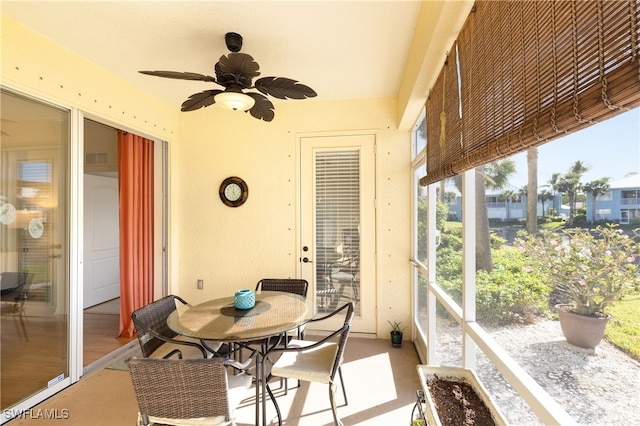 sunroom / solarium featuring ceiling fan