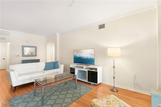 living room featuring crown molding and hardwood / wood-style flooring