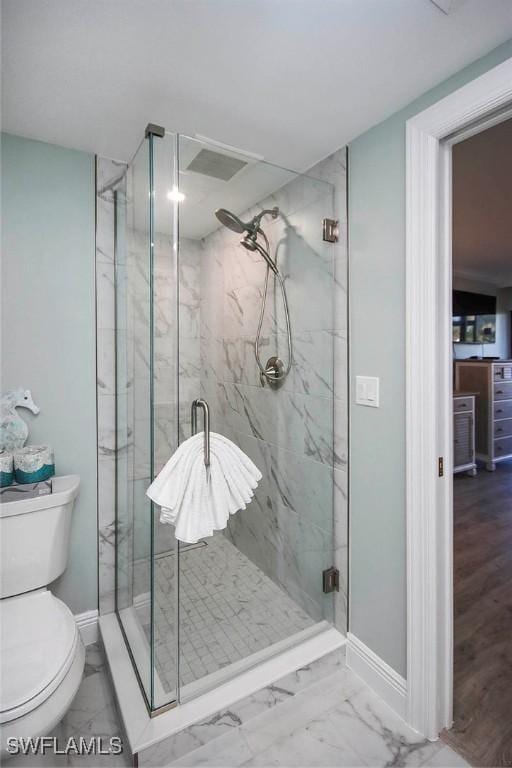 bathroom with toilet and a shower with shower door