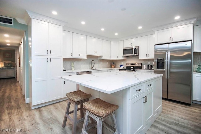 kitchen featuring white cabinets and appliances with stainless steel finishes