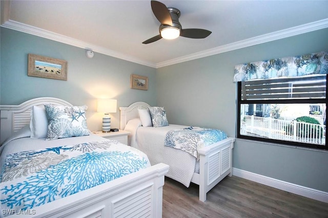 bedroom featuring ceiling fan, dark hardwood / wood-style flooring, and ornamental molding