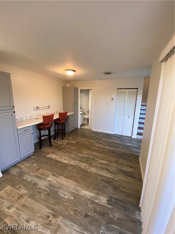 interior space featuring built in desk and dark hardwood / wood-style floors