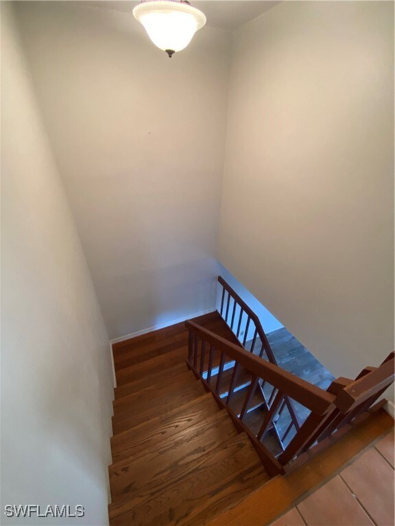 stairway with hardwood / wood-style floors