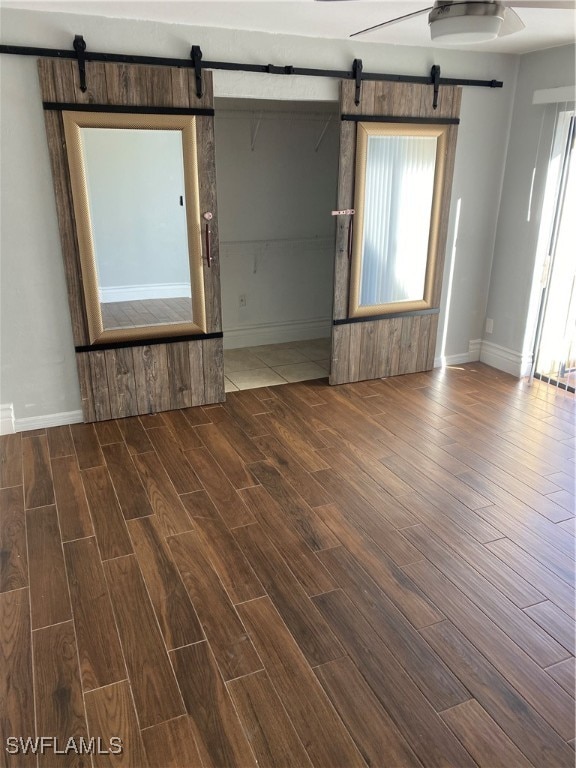 empty room with wood-type flooring and ceiling fan